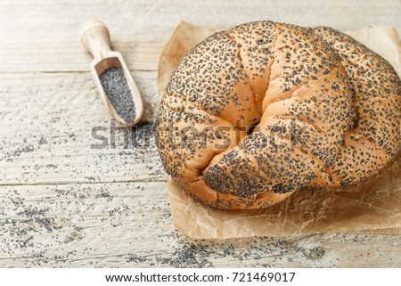 Fresh homemade bagels with poppy seeds for Breakfast on a wooden table. Selective focus. Copy space