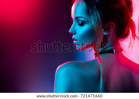 High Fashion model woman in colorful bright lights posing, portrait of beautiful  girl with trendy make-up. Art design, colorful make up. Over colourful vivid background.  Royalty-Free Stock Photo #721471660