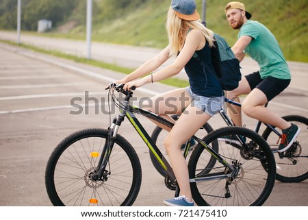 Side view of a young couple on cycle ride in countryside
