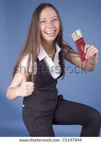 portrait of young happy student with money and passport. Foreign vacations
