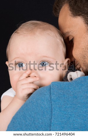 Young Father giving a kiss to his son