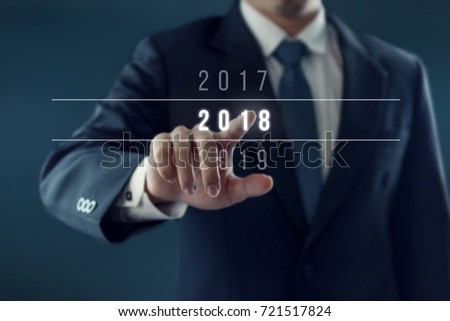 Businessman pointing year 2018. Business new year card concept. Royalty-Free Stock Photo #721517824