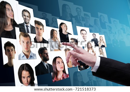 Businessman hand going through candidate picture gallery on blue background. Social media and recruiting concept 