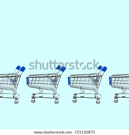 Shopping cart isolated on blue background with place for text. Sale concept.