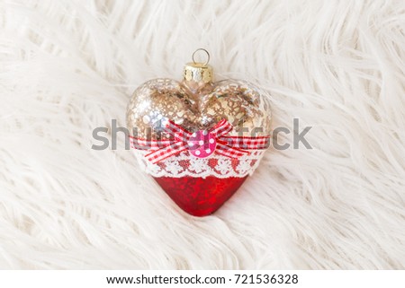 Beautiful Christmas toy in the form of a heart on a white background.New Year. Christmas. Wooden Background