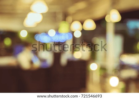 Coffee shop and people sit on table blur background with bokeh image .(vintage tone)