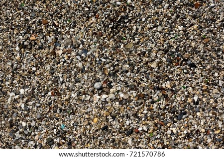 Abstract background with pebbles. Round sea multicolored stones. Small pebbles.