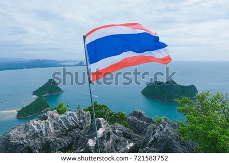Thai Flag on top of mountain and blue sea blue sky view behind