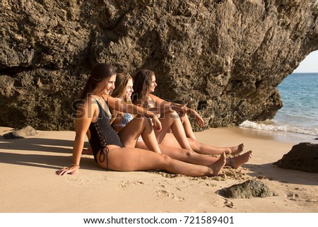 group of beautiful friends posing at the beach