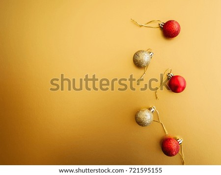 Red Gold Christmas Balls on golden background. Selective Focus. Copy Space. Top View.
