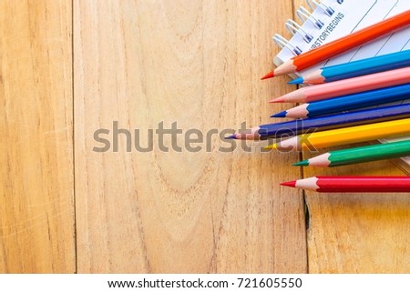   Notepad with pencil on wood board background.using wallpaper for education, business photo.Take note of the product for book with paper and concept, object or copy space.