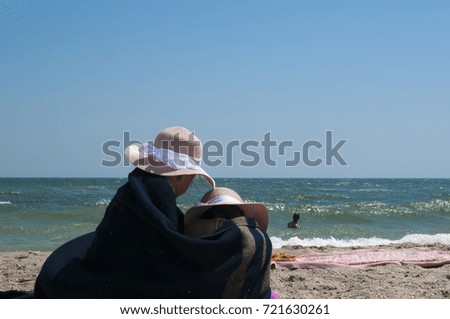 Silhouettes of girls covered with a blanket on the beach