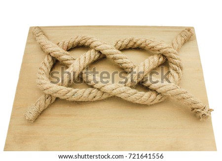 Carrick Bend Knot on wooden desk isolated on white background. Most secure waterproof option for very heavy rope or cable. Commonly used in navy training. Sailing, military, ship security concept