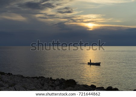 Fishingboat at Adriatic Sea in Razanj Croatia. Beautiful autumn evening at sunset. Nice peaceful outdoors image. Lovely landscape and nature picture. Joyful and happy.