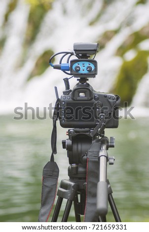 Camera ready to shoot. Blured nature waterfall landscape