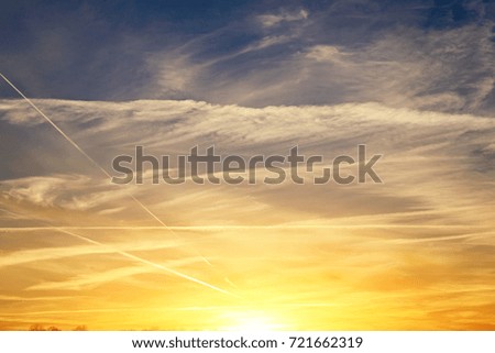 Background of the sunset with blue and gold cloudy sky.