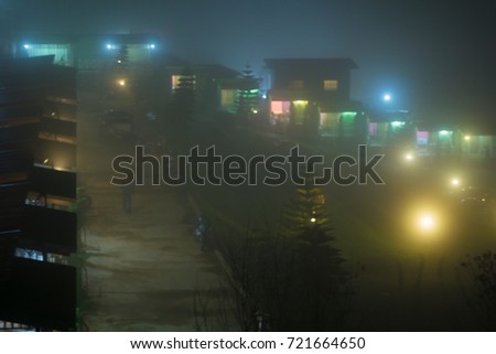 Misty night village in the winter.