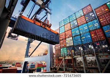 Container loading in a Cargo freight ship with industrial crane. Container ship in import and export business logistic company. Industry and Transportation concept. Royalty-Free Stock Photo #721673605