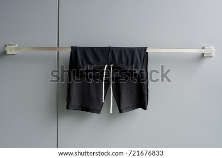 drying man swimming suit on wall background from swimming pool.