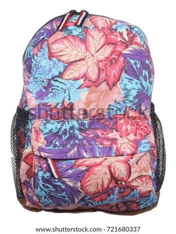Front view of colored textile female backpack with autumn leaves pictured, zippers, straps and handle, isolated on white