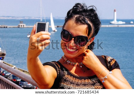 Happy travel woman selfie taking pictures of herself at port
