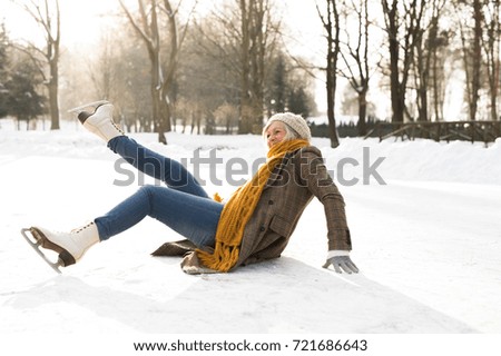 Senior woman on the ice after a fall.