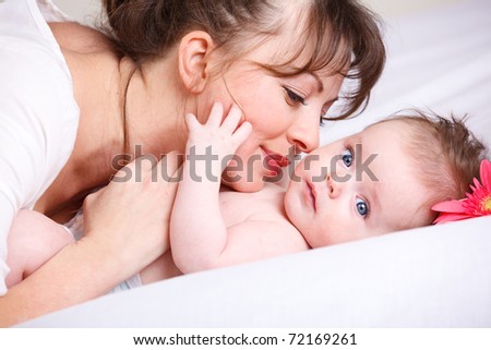 Mom playing with cute baby