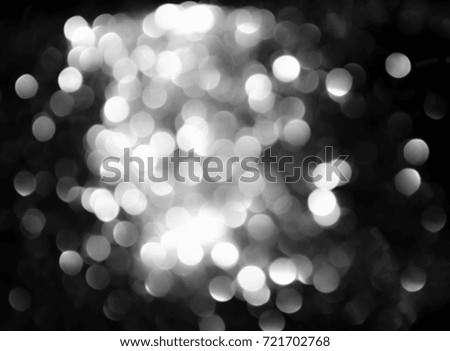 Bokeh silver and white Sparkling Lights Festive background with texture. Abstract Christmas twinkled bright defocused and Falling stars. Winter Card or invitation.