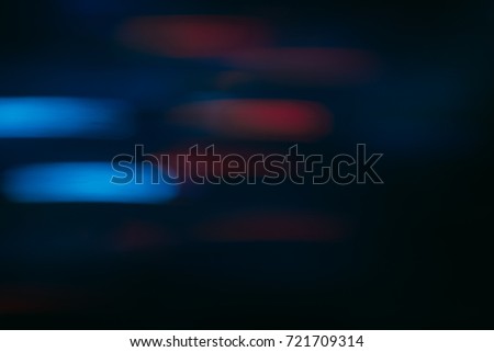 Abstract background of colorful blurs in motion on black. Bokeh of defocused streaks, blurred neon blue and red leds, glowing city lights and traffic, wallpapers and banners