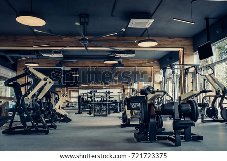 Modern light gym. Sports equipment in gym. Barbells of different weight on rack. Royalty-Free Stock Photo #721723375