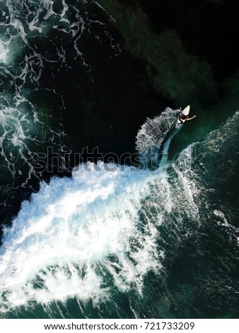 Deep ocean. A lonely surfer. The background wallpaper. The picture is taken from the drone.