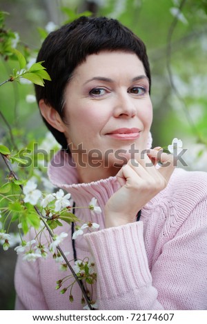 Portrait of beautiful middle aged woman in spring