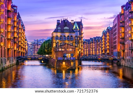 The Warehouse District (Speicherstadt) in Hamburg, Germany, at dusk. View of Wandrahmsfleet. The largest warehouse district in the world is located in the port of Hamburg within the HafenCity quarter. Royalty-Free Stock Photo #721752376