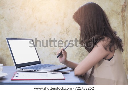 young business woman working in office, typing looking Notebook screen Empty white. Template for your content. Business finance concept.