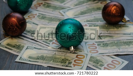 A Christmas tree from dollars (money) on a wooden background.