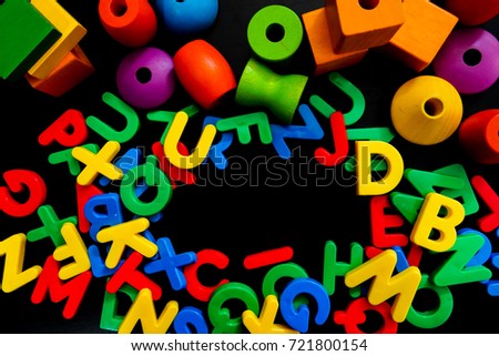 Border of colorful plastic letters , loop and wooden shape  with copy-space