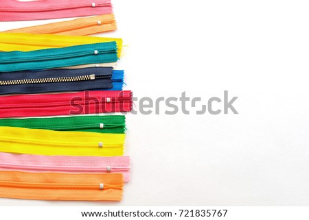 Colorful zippers on white background Royalty-Free Stock Photo #721835767