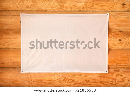 empty flag of cloth hanging wooden blockhouse wall made of cylindered logs