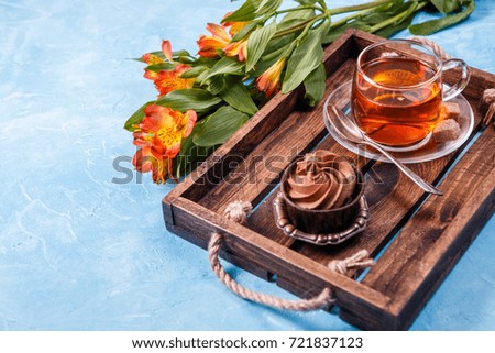 Photo of breakfast with cupcake, orange flowers