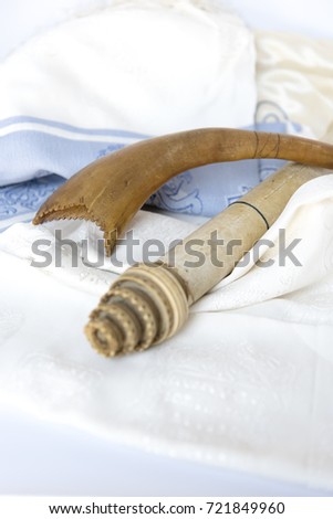 Rosh Hashanah (Hashana) jewish New Year holiday and Yom Kippur concept with Ram shofar (horn)  in focus and scroll not on focus