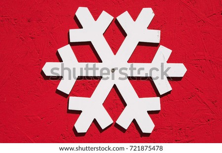 White snowflake isolated on red background