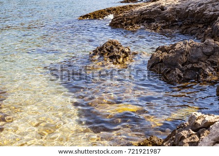 Scenic picture beautiful clear water and rocks at the seashore on summertime