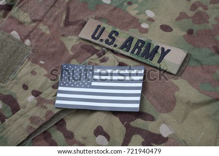US flag patch with dog tag on multicam camouflage uniform