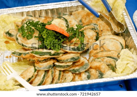 zucchini tempura in a aluminum tray 