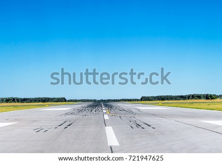 Runway at the airport with good weather and clear blue sky