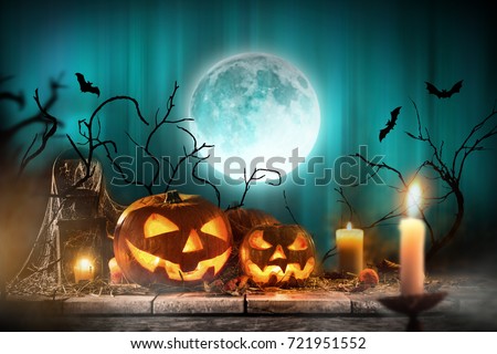 Halloween pumpkins on wooden planks with spooky background.