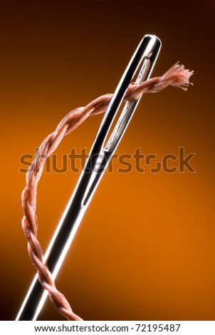 Metal needle and string. Very much a close up. Art background. Royalty-Free Stock Photo #72195487