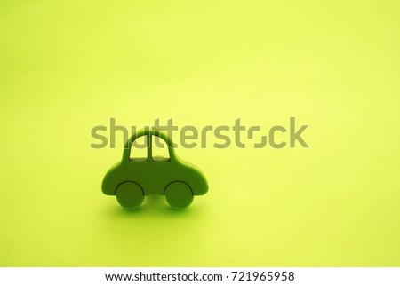  green plastic cars toy figure. view on paper green background. eco, bio sign, symbol, concept, idea. 