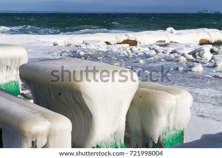 Winter seascape. Snow, ice huge waves beating against the shore and freezes. Natural disaster in form of storms and severe frosts led to icing of the black sea coast near Odessa. 