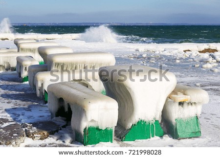Winter seascape. Snow, ice huge waves beating against the shore and freezes. Natural disaster in form of storms and severe frosts led to icing of the black sea coast near Odessa. 